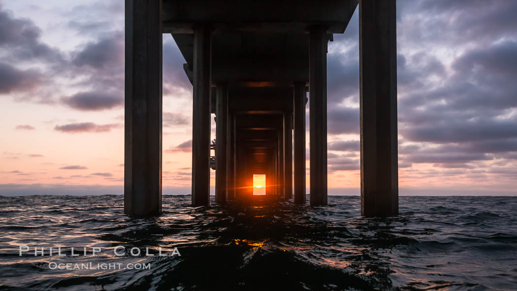 Scripps Pier solstice, surfer's view from among the waves, sunset aligned perfectly with the pier. Research pier at Scripps Institution of Oceanography SIO, sunset. La Jolla, California, USA, natural history stock photograph, photo id 30152