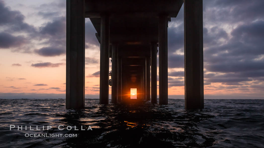 Scripps Pier solstice, surfer's view from among the waves, sunset aligned perfectly with the pier. Research pier at Scripps Institution of Oceanography SIO, sunset. La Jolla, California, USA, natural history stock photograph, photo id 30151
