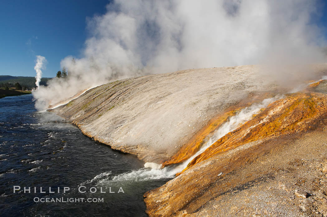 Thermophilac heat-loving bacteria color the runoff canals from Excelsior Geyser as it empties into the Firehole River. Midway Geyser Basin, Yellowstone National Park, Wyoming, USA, natural history stock photograph, photo id 13594