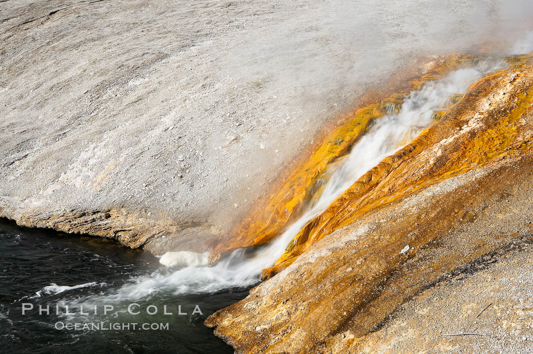 Thermophilac heat-loving bacteria color the runoff canals from Excelsior Geyser as it empties into the Firehole River. Midway Geyser Basin, Yellowstone National Park, Wyoming, USA, natural history stock photograph, photo id 13599