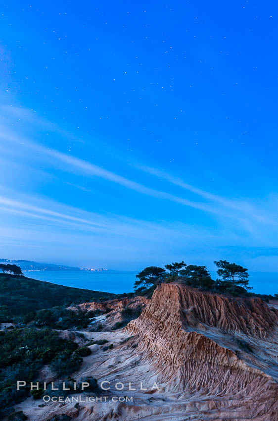 Torrey Pines State Reserve at Night, stars and clouds fill the night sky with the lights of La Jolla visible in the distance. San Diego, California, USA, natural history stock photograph, photo id 28394