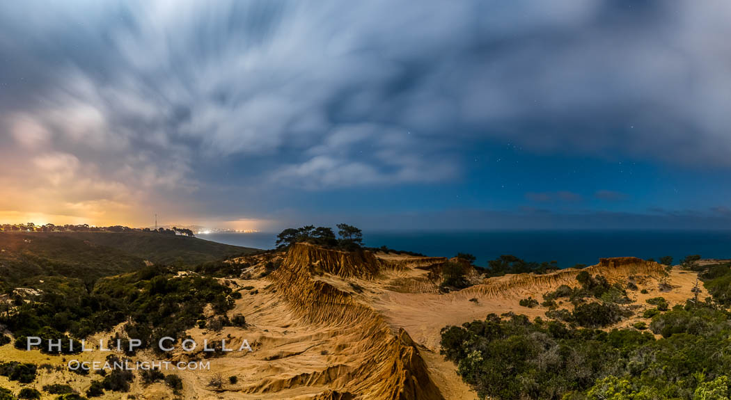 Torrey Pines State Reserve at Night, stars and clouds fill the night sky with the lights of La Jolla visible in the distance. San Diego, California, USA, natural history stock photograph, photo id 28405