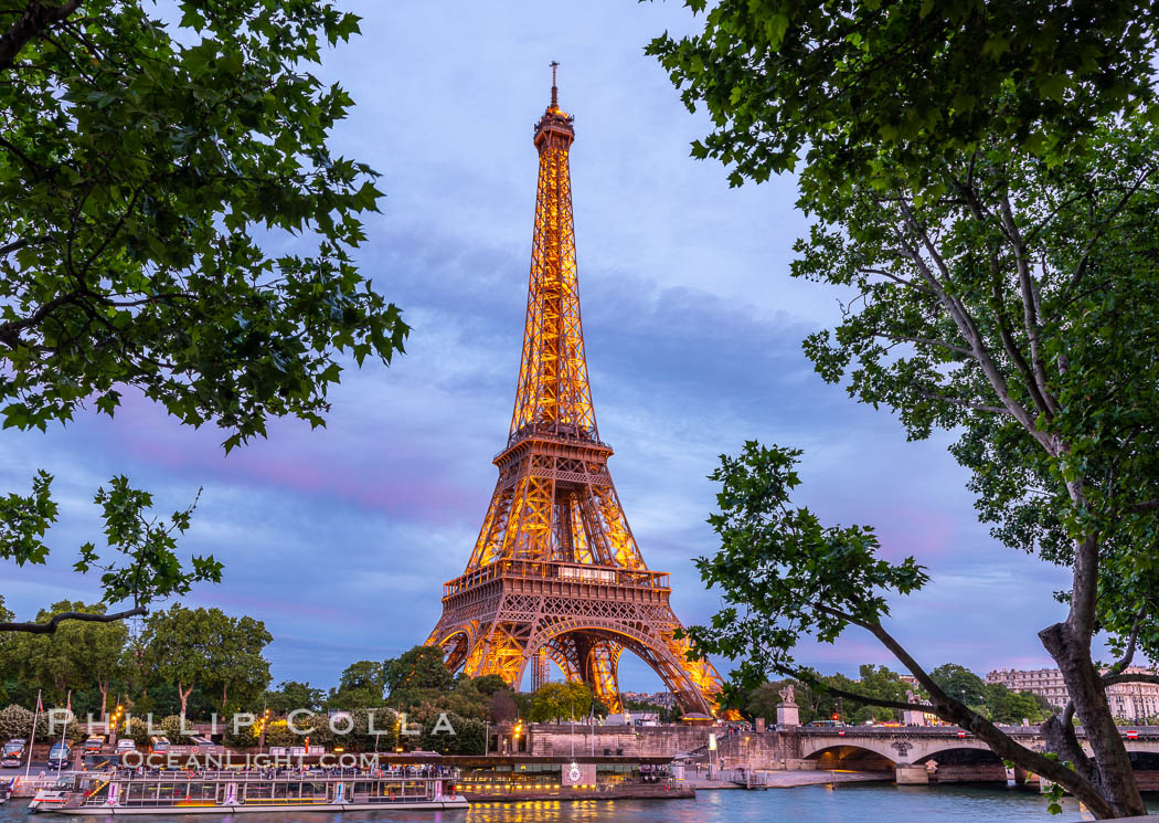 La Tour Eiffel at dusk over the River Seine in Paris France. The Eiffel Tower is an iron lattice tower located on the Champ de Mars in Paris, named after the engineer Gustave Eiffel, who designed the tower in 1889 as the entrance arch to the 1889 World's Fair. The Eiffel tower is the tallest structure in Paris and the most-visited paid monument in the world., natural history stock photograph, photo id 35677