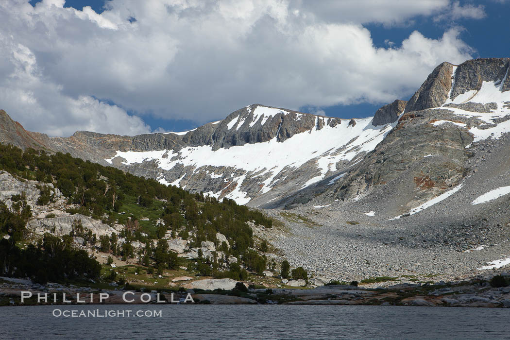 Townsley Lake, a beautiful alpine lake sitting below blue sky, clouds and Fletcher Peak (right), lies amid the Cathedral Range of glacier-sculpted granite peaks in Yosemite's high country, near Vogelsang High Sierra Camp. Yosemite National Park, California, USA, natural history stock photograph, photo id 23254