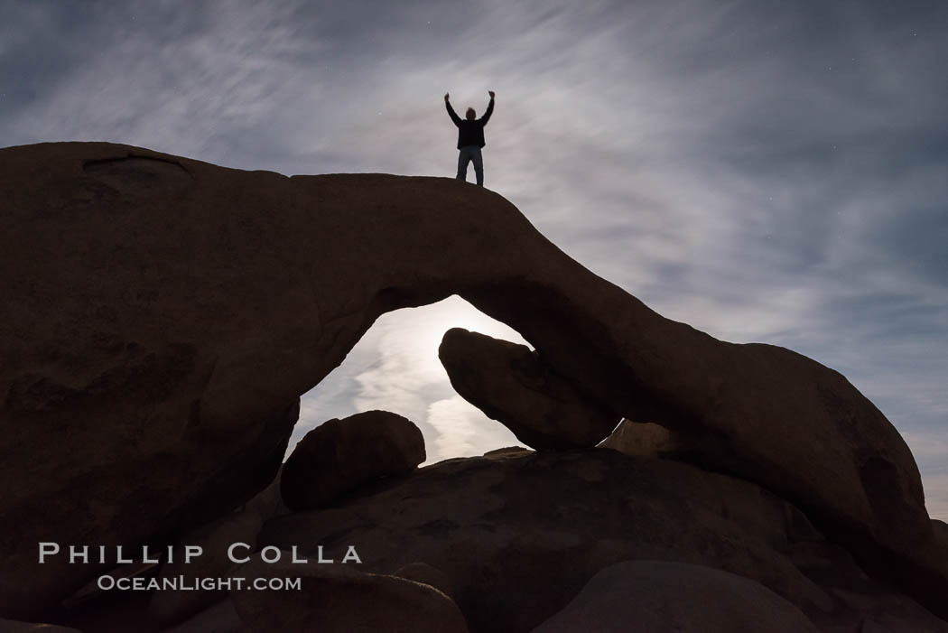 Triumphant Guy Atop Arch Rock in Full Moon., natural history stock photograph, photo id 30712