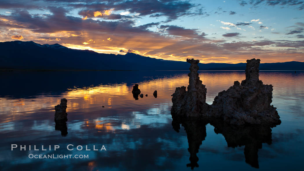 Tufa towers rise from Mono Lake, with the Eastern Sierra visible in the distance. Tufa towers are formed when underwater springs rich in calcium mix with lakewater rich in carbonates, forming calcium carbonate (limestone) structures below the surface of the lake. The towers were eventually revealed when the water level in the lake was lowered starting in 1941. California, USA, natural history stock photograph, photo id 26983