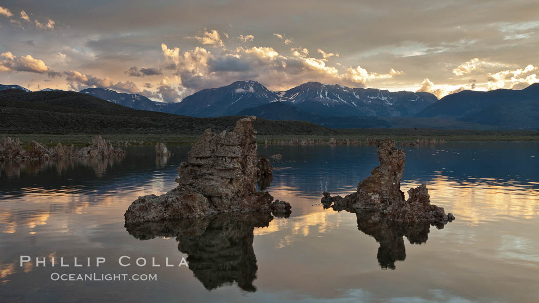 Tufa towers rise from Mono Lake, with the Eastern Sierra visible in the distance. Tufa towers are formed when underwater springs rich in calcium mix with lakewater rich in carbonates, forming calcium carbonate (limestone) structures below the surface of the lake. The towers were eventually revealed when the water level in the lake was lowered starting in 1941. California, USA, natural history stock photograph, photo id 27003