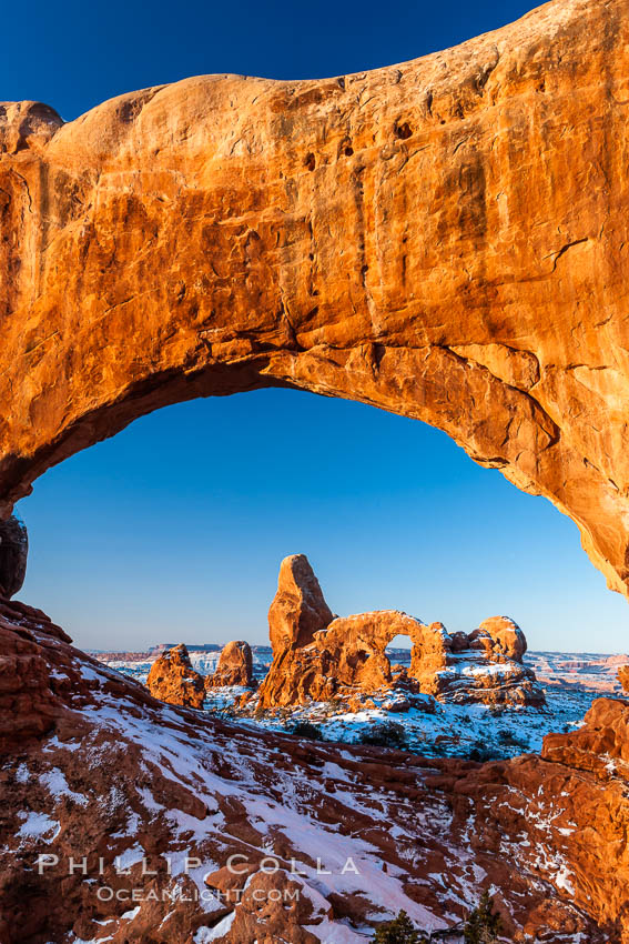 Sunrise light on Turret Arch viewed through North Window, winter. Arches National Park, Utah, USA, natural history stock photograph, photo id 18121