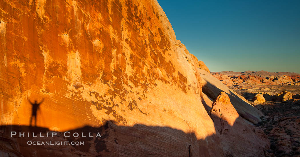 Rising sun creates the photographers shadow on a sandstone wall. Valley of Fire State Park, Nevada, USA, natural history stock photograph, photo id 26505