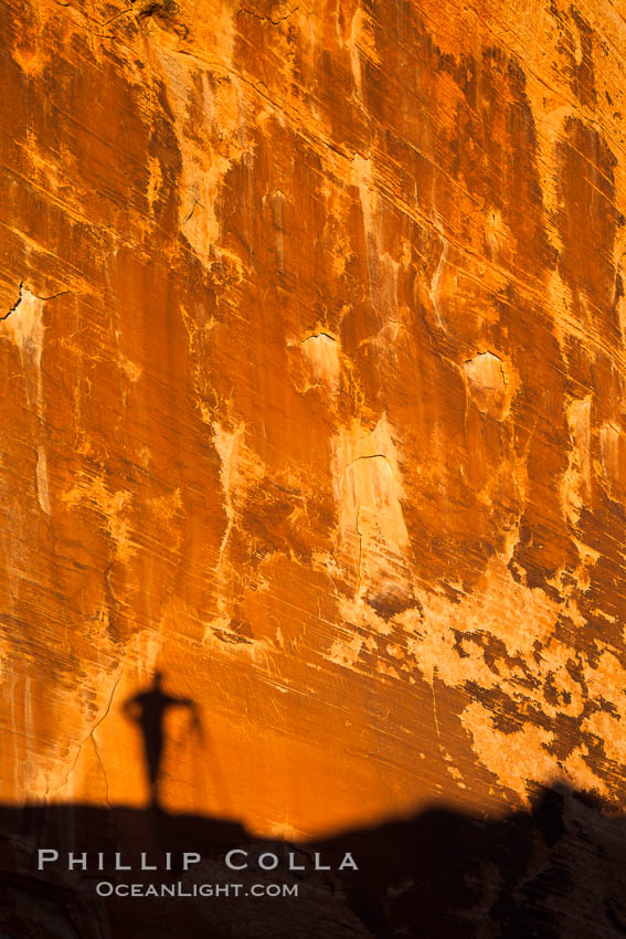 Rising sun creates the photographers shadow on a sandstone wall. Valley of Fire State Park, Nevada, USA, natural history stock photograph, photo id 26513