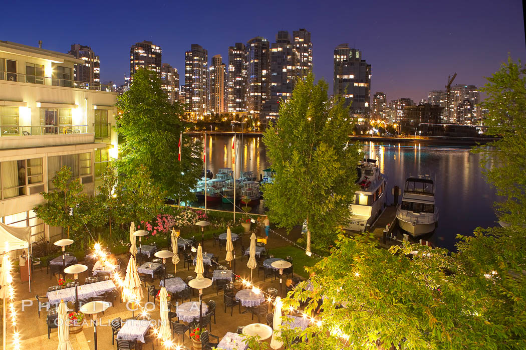Vancouver and harbor at night, viewed from Granville Island Hotel with restaurant courtyard in the foreground. British Columbia, Canada, natural history stock photograph, photo id 21170
