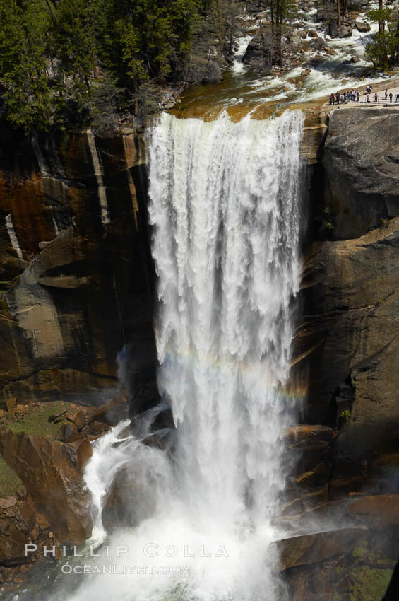 Vernal Falls at peak flow in late spring. Hikers are seen at the precipice to Vernal Falls, having hiked up the Mist Trail to get there. Yosemite National Park, California, USA, natural history stock photograph, photo id 12640