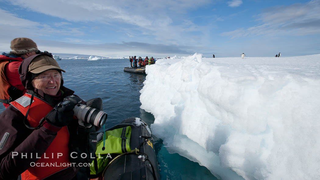 Visitors enjoy a look at penguins on an iceberg from an inflatable boat. Paulet Island, Antarctic Peninsula, Antarctica, natural history stock photograph, photo id 25001