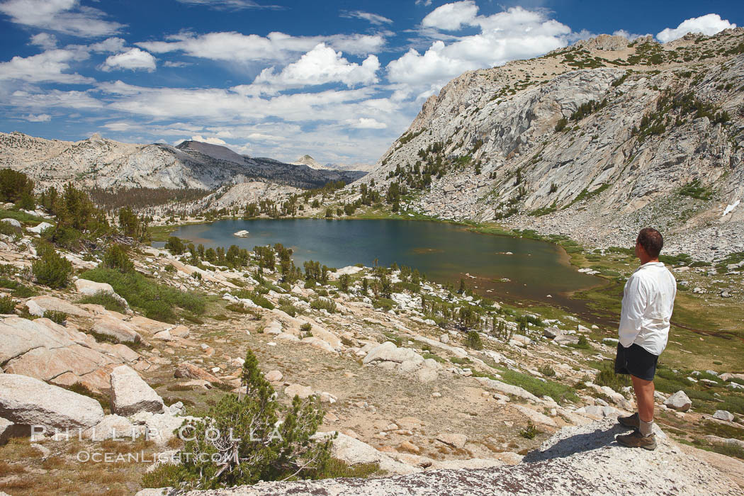 Hiker views Vogelsang Lake and the western buttress of Fletcher Peak from a vantage point near Vogelsang Pass, looking north. Yosemite National Park, California, USA, natural history stock photograph, photo id 23216