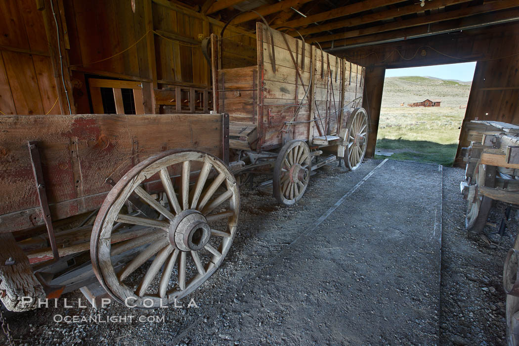 Wagon and interior of County Barn, Brown House and Moyle House in distance. Bodie State Historical Park, California, USA, natural history stock photograph, photo id 23142