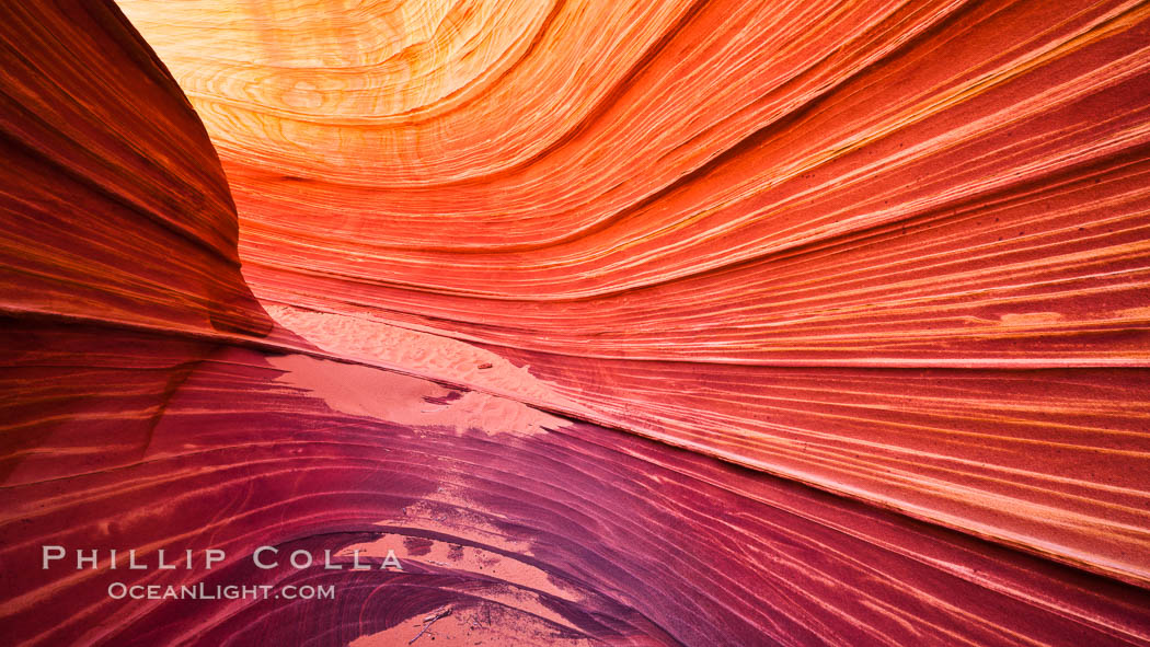 The Wave, an area of fantastic eroded sandstone featuring beautiful swirls, wild colors, countless striations, and bizarre shapes set amidst the dramatic surrounding North Coyote Buttes of Arizona and Utah.  The sandstone formations of the North Coyote Buttes, including the Wave, date from the Jurassic period. Managed by the Bureau of Land Management, the Wave is located in the Paria Canyon-Vermilion Cliffs Wilderness and is accessible on foot by permit only. USA, natural history stock photograph, photo id 20621