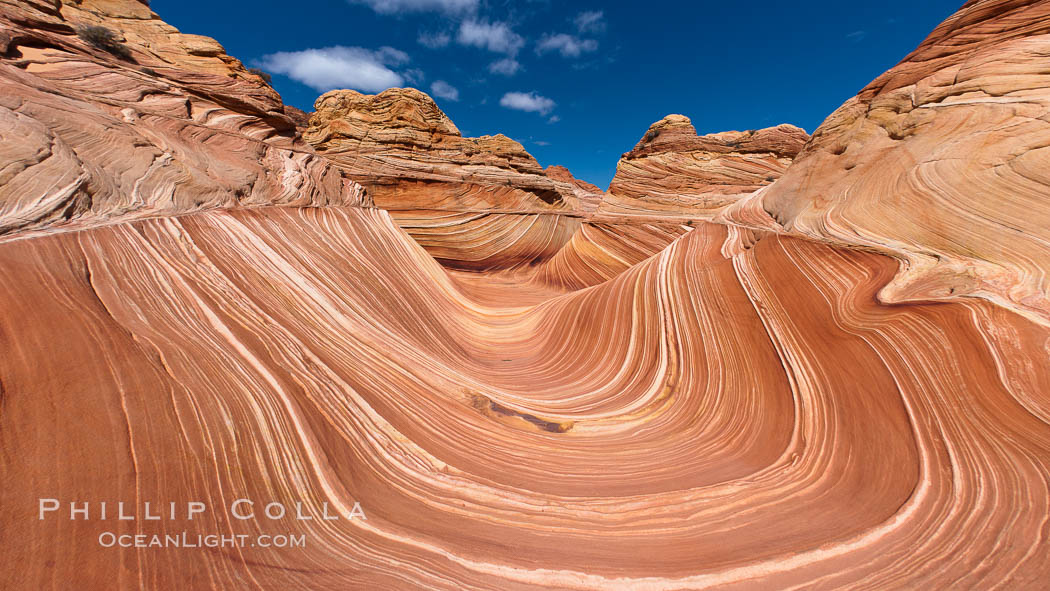 The Wave, an area of fantastic eroded sandstone featuring beautiful swirls, wild colors, countless striations, and bizarre shapes set amidst the dramatic surrounding North Coyote Buttes of Arizona and Utah.  The sandstone formations of the North Coyote Buttes, including the Wave, date from the Jurassic period. Managed by the Bureau of Land Management, the Wave is located in the Paria Canyon-Vermilion Cliffs Wilderness and is accessible on foot by permit only. USA, natural history stock photograph, photo id 20679