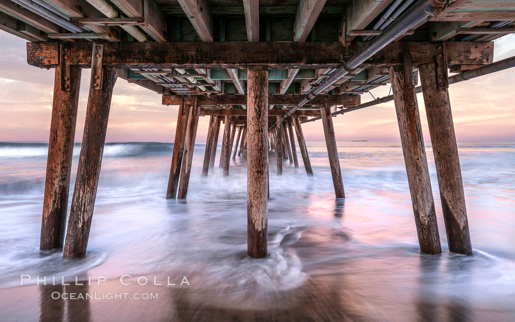 Waves break on the Imperial Beach Pier pilings, at dawn with colorful sunrise clouds over the ocean. California, USA, natural history stock photograph, photo id 37706