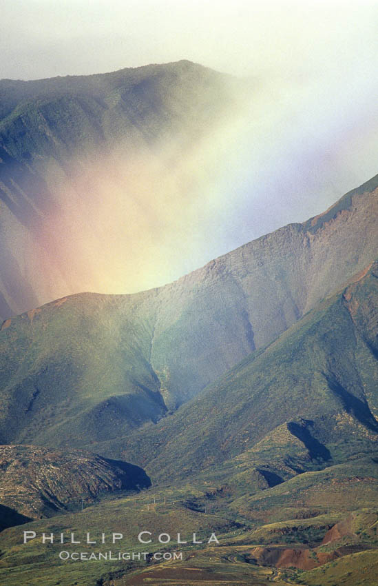 West Maui mountains rise above the coast of Maui, with clouds flanking the ancient eroded remnants of a volcano. Hawaii, USA, natural history stock photograph, photo id 05861