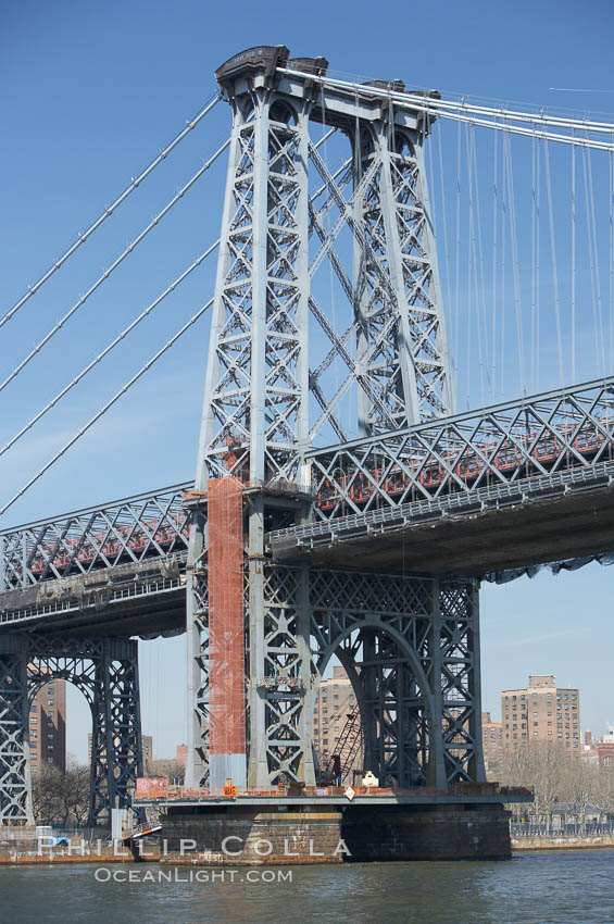 The Williamsburg Bridge viewed from the East River.  The Williamsburg Bridge is a suspension bridge in New York City across the East River connecting the Lower East Side of Manhattan at Delancey Street with the Williamsburg neighborhood of Brooklyn on Long Island at Broadway near the Brooklyn-Queens Expressway. USA, natural history stock photograph, photo id 11123