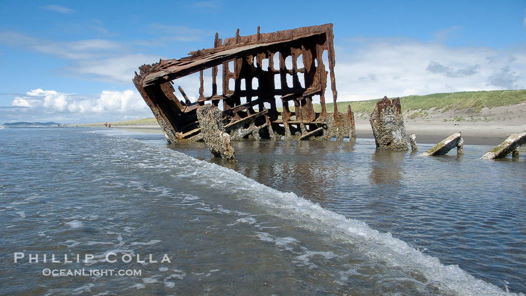Wreck of the Peter Iredale, rusting away in the sand at the ocean's edge., natural history stock photograph, photo id 19447