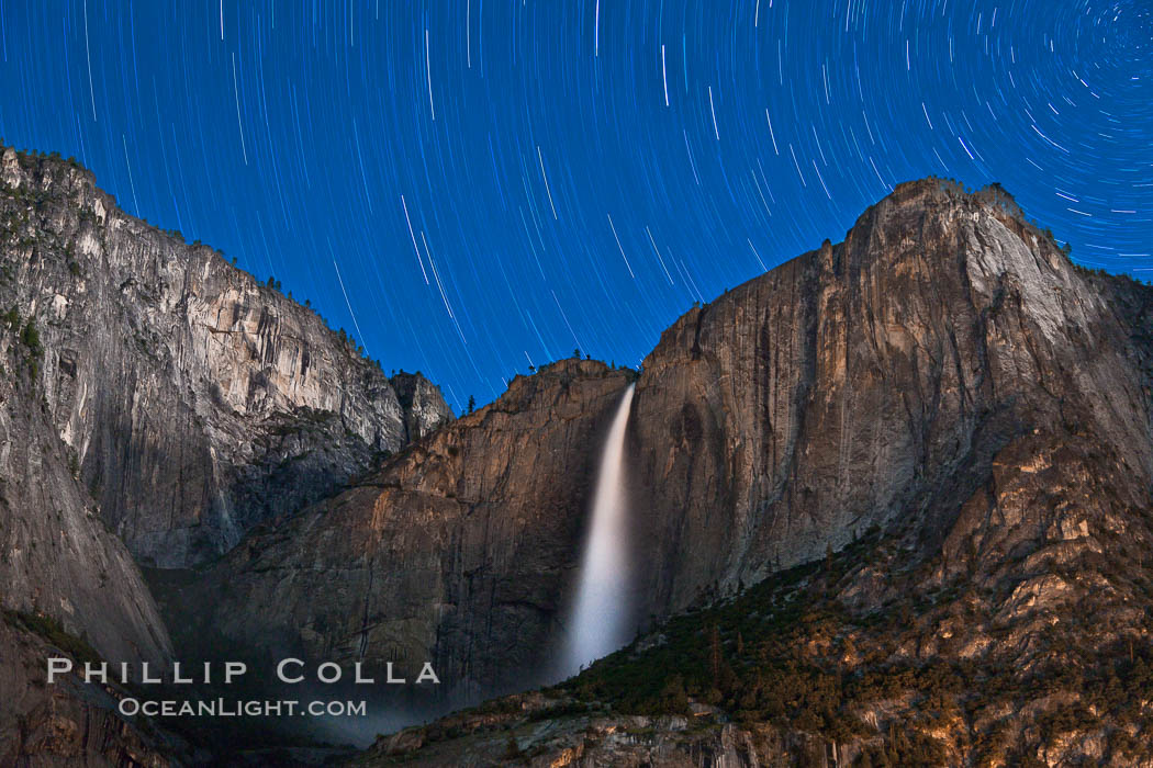 Yosemite Falls and star trails, night sky time exposure of Yosemite Falls waterfall in full spring flow, with star trails arcing through the night sky. Yosemite National Park, California, USA, natural history stock photograph, photo id 26852