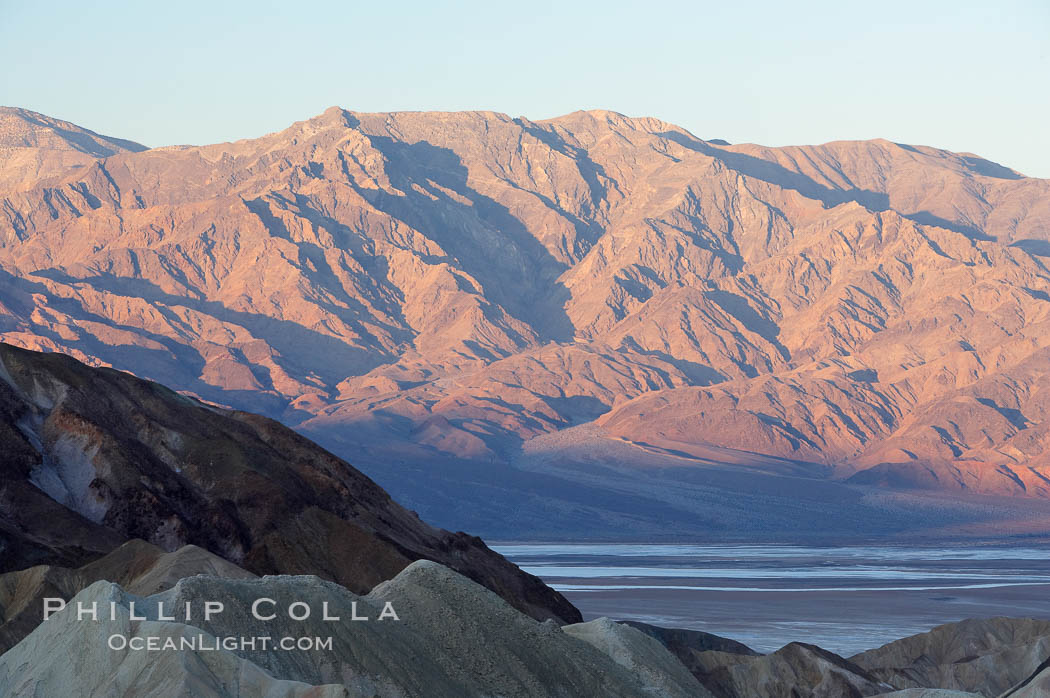 Zabriskie Point, sunrise.  Curiously banded area of sedimentary rock lies in the foreground with the Panamint Mountains visible in the distance. Death Valley National Park, California, USA, natural history stock photograph, photo id 15601