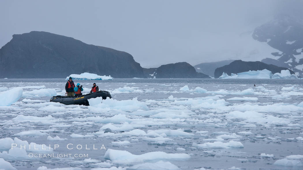 Zodiac cruising in Antarctica.  Motoring in an inflatable zodiac through pack ice along the Antarctic Peninsula. Cierva Cove, natural history stock photograph, photo id 25563