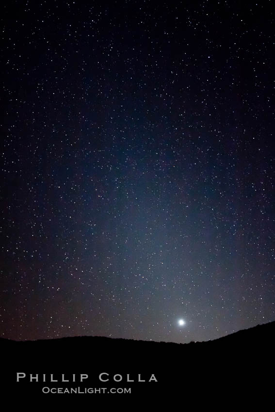 Zodiacal light over Death Valley.  Zodiacal light is a faint diffuse light seen along the plane of the ecliptic in the vicinity of the setting or rising sun, caused by sunlight scattered off space dust in the zodiacal cloud. Racetrack Playa, Death Valley National Park, California, USA, natural history stock photograph, photo id 27692