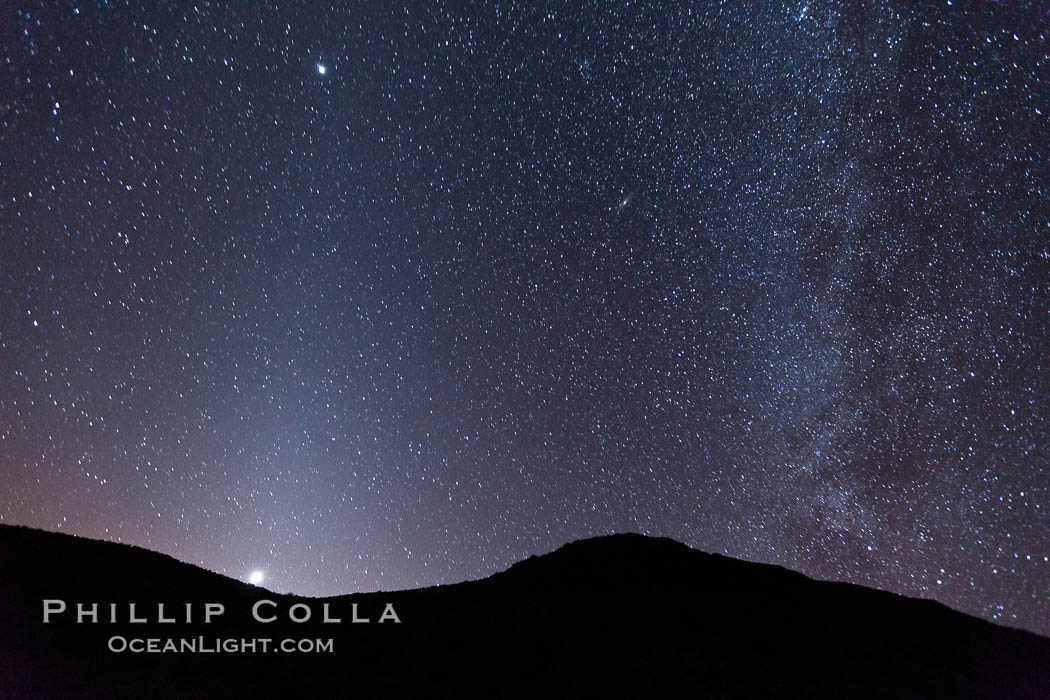 Zodiacal light and Milky Way over Death Valley.  Zodiacal light is a faint diffuse light seen along the plane of the ecliptic in the vicinity of the setting or rising sun, caused by sunlight scattered off space dust in the zodiacal cloud. Racetrack Playa, Death Valley National Park, California, USA, natural history stock photograph, photo id 27693